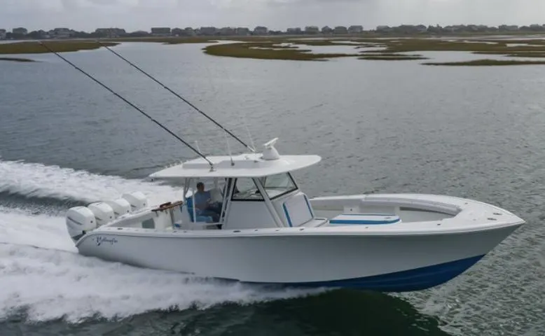 Slide: The Image of 2018 Yellowfin 39 boat cruising on water with fishing rods. - 2