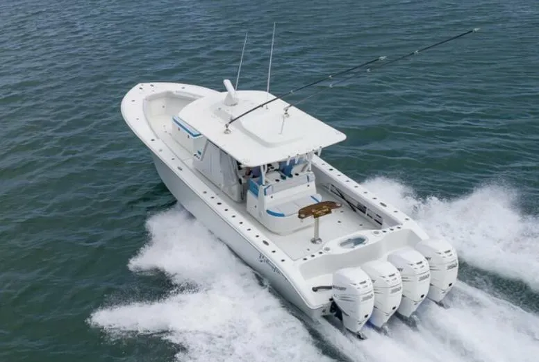 Slide: The Image of 2018 Yellowfin 39 boat with four outboard engines cruising on water. - 7