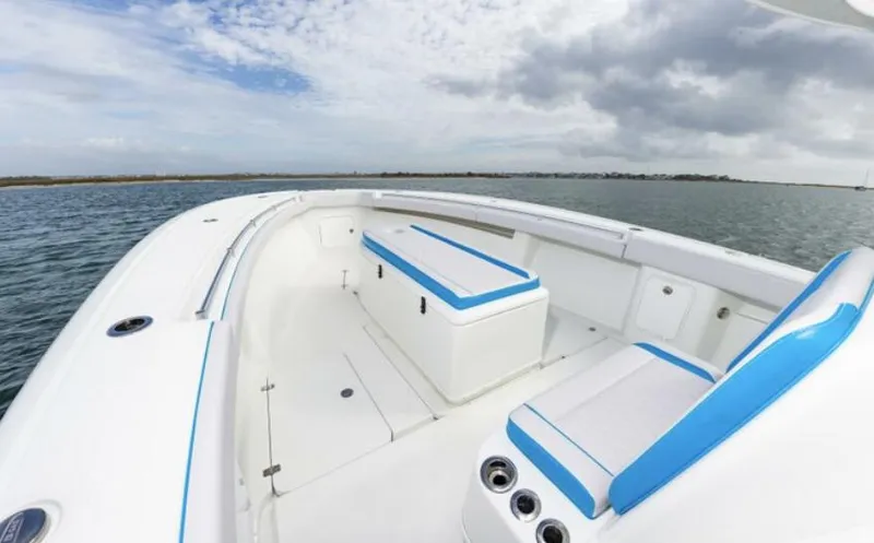 Slide: The Image of 2018 Yellowfin 39 boat with white and blue seating on open water. - 8