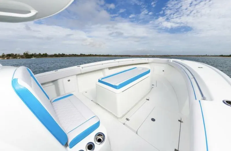 Slide: The Image of 2018 Yellowfin 39 boat with white and blue seating on open water. - 9