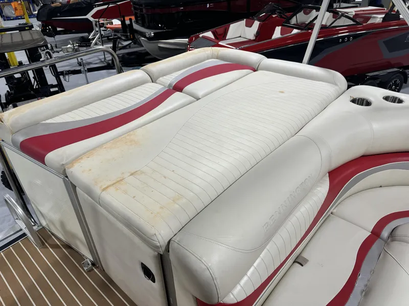 Slide: The Image of 2007 Bennington 2275 RL boat with white and red upholstery, showing signs of wear. - 3
