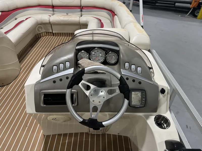 Slide: The Image of 2007 Bennington 2275 RL boat dashboard with steering wheel and seating area. - 5