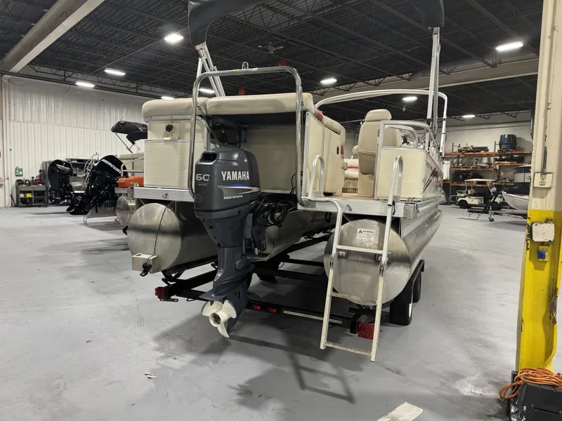 Slide: The Image of 2007 Bennington 2275 RL pontoon boat with Yamaha 60 HP outboard motor in a workshop. - 7