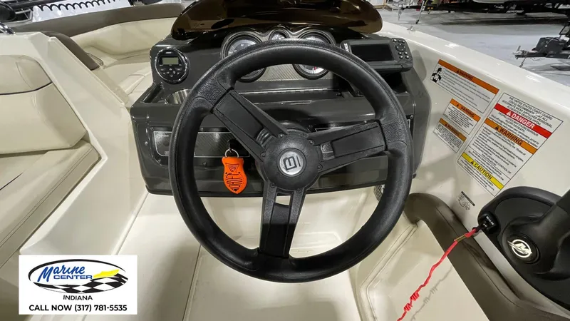 Slide: The Image of 2019 Bayliner 190 Deck Boat dashboard with steering wheel and control panel. - 12