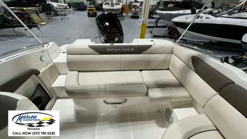 Slide: The Image of 2019 Bayliner 190 Deck Boat interior with beige seating, displayed at Marine Center Indiana. - 13