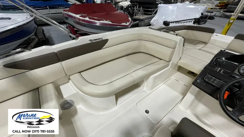 Slide: The Image of 2019 Bayliner 190 Deck Boat interior with beige seating, displayed at Marine Center Indiana. - 2