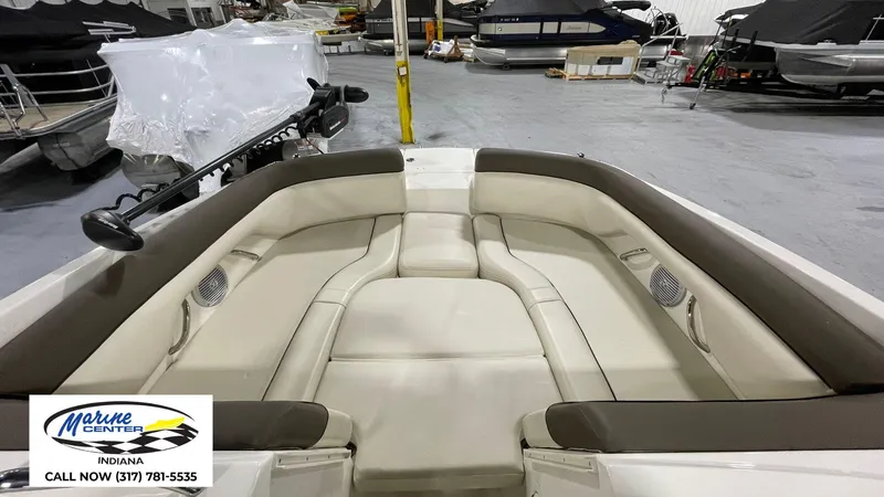Slide: The Image of 2019 Bayliner 190 Deck Boat interior with beige seating, displayed at Marine Center Indiana. - 9