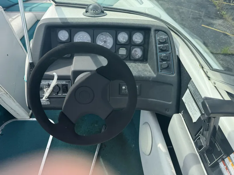 Slide: The Image of 1993 Chaparral 2000SL boat dashboard with steering wheel and control panel. - 5