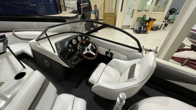 Slide: The Image of Interior of a 1996 Tigé PRE2002WT boat with white seating and dashboard. - 5