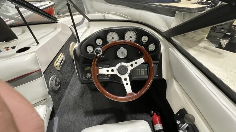 Slide: The Image of Interior of 1996 Tigé PRE2002WT boat with wooden steering wheel and dashboard gauges. - 6