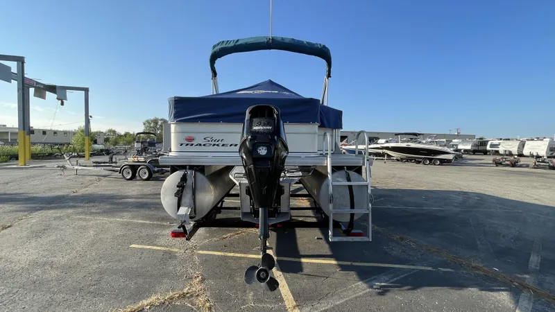 Slide: The Image of 2007 Sun Tracker Fishing Deck 21 boat with Mercury outboard motor in parking lot. - 10