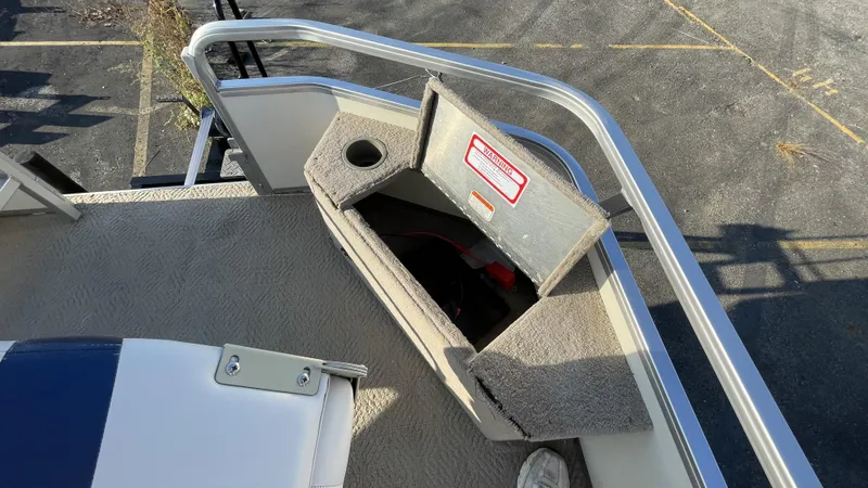 Slide: The Image of 2007 Sun Tracker Fishing Deck 21 boat with open storage compartment and cup holder. - 13