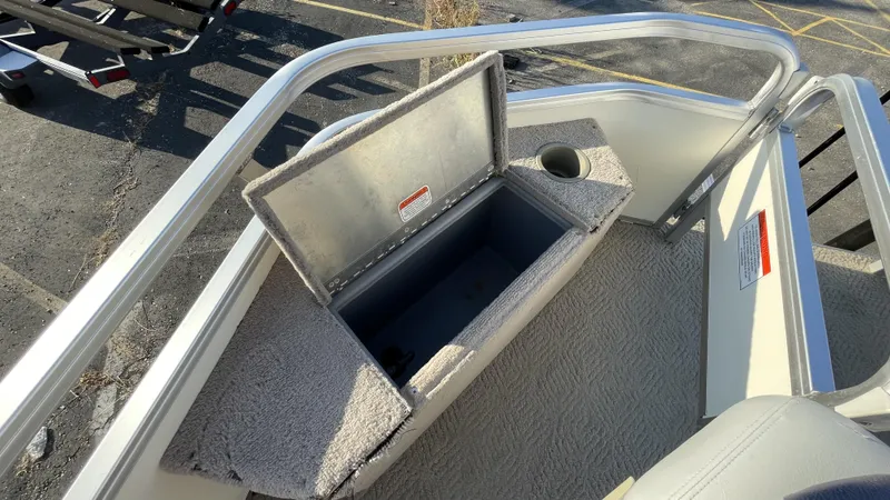 Slide: The Image of 2007 Sun Tracker Fishing Deck 21 boat storage compartment with cup holder. - 14
