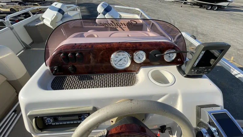 Slide: The Image of 2007 Sun Tracker Fishing Deck 21 dashboard with gauges and Lowrance fish finder. - 15