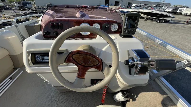 Slide: The Image of 2007 Sun Tracker Fishing Deck 21 boat dashboard with steering wheel and controls. - 4