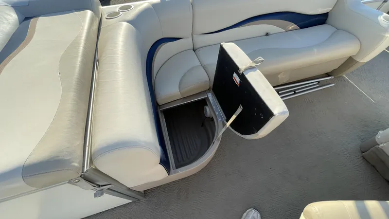 Slide: The Image of 2007 Sun Tracker Fishing Deck 21 boat interior with open storage compartment. - 5