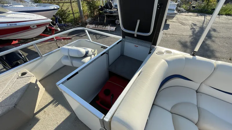 Slide: The Image of 2007 Sun Tracker Fishing Deck 21 boat interior with open storage compartment and seating. - 6