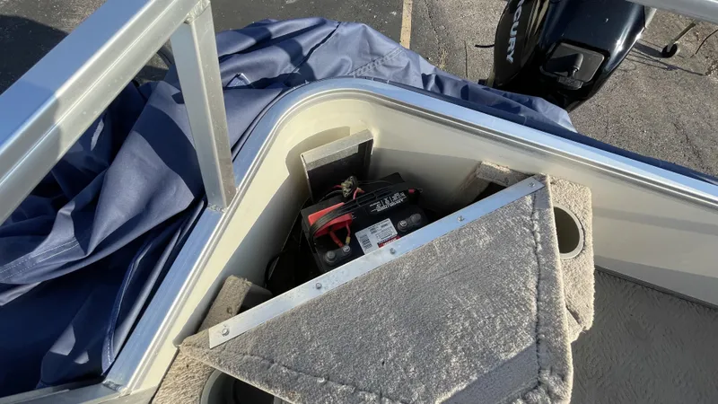 Slide: The Image of 2007 Sun Tracker Fishing Deck 21 boat battery compartment with Mercury outboard motor. - 8