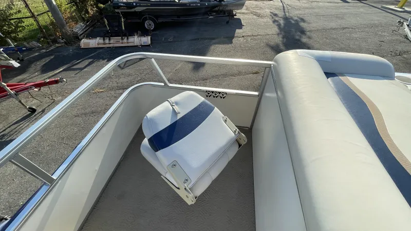 Slide: The Image of 2007 Sun Tracker Fishing Deck 21 boat interior with seating and railing. - 9