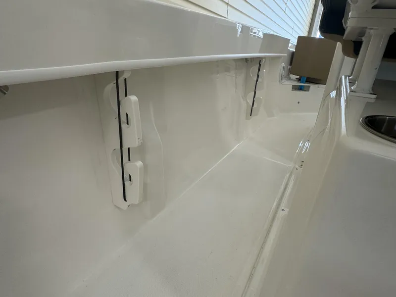 Slide: The Image of 2024 Bayliner TROPHY CC20 boat interior, featuring clean white surfaces and storage compartments. - 10