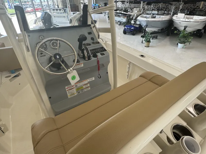 Slide: The Image of 2024 Bayliner TROPHY CC20 boat interior with steering wheel and control panel. - 11