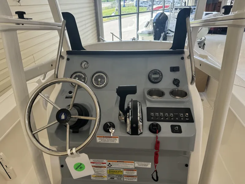 Slide: The Image of 2024 Bayliner TROPHY CC20 boat console with steering wheel, gauges, and controls. - 3