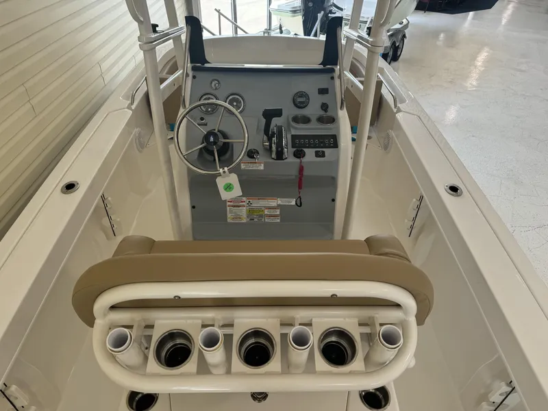 Slide: The Image of 2024 Bayliner TROPHY CC20 center console boat interior with steering wheel and rod holders. - 8