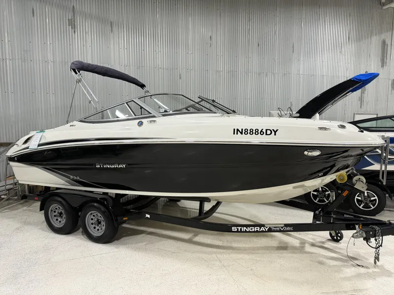 Slide: The Image of 2017 Stingray 215LR boat on trailer in indoor storage. - 1