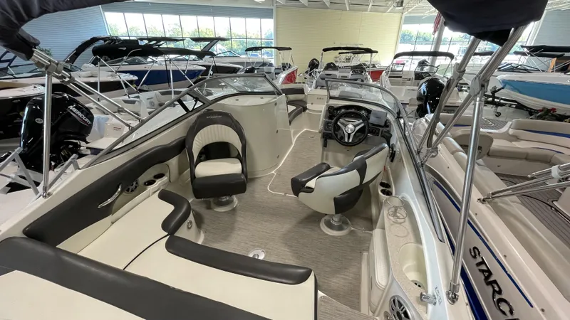 Slide: The Image of 2017 Stingray 215LR boat interior with seating and steering wheel in showroom. - 3