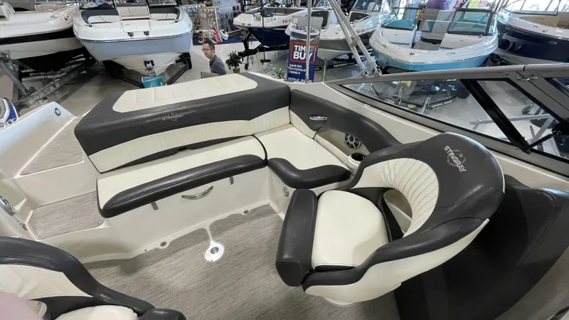 Slide: The Image of 2017 Stingray 215LR boat interior with black and white seating in showroom. - 5
