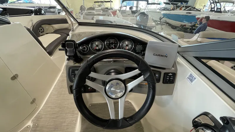 Slide: The Image of 2017 Stingray 215LR boat dashboard with Garmin navigation system and steering wheel. - 6