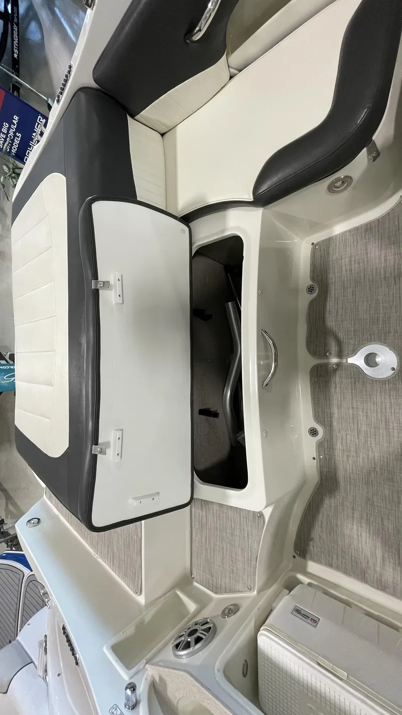 Slide: The Image of 2017 Stingray 215LR boat interior with open storage compartment and seating. - 7