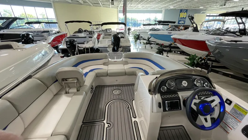 Slide: The Image of 2019 Starcraft Starstep 221 boat interior in showroom, featuring sleek design and modern dashboard. - 3