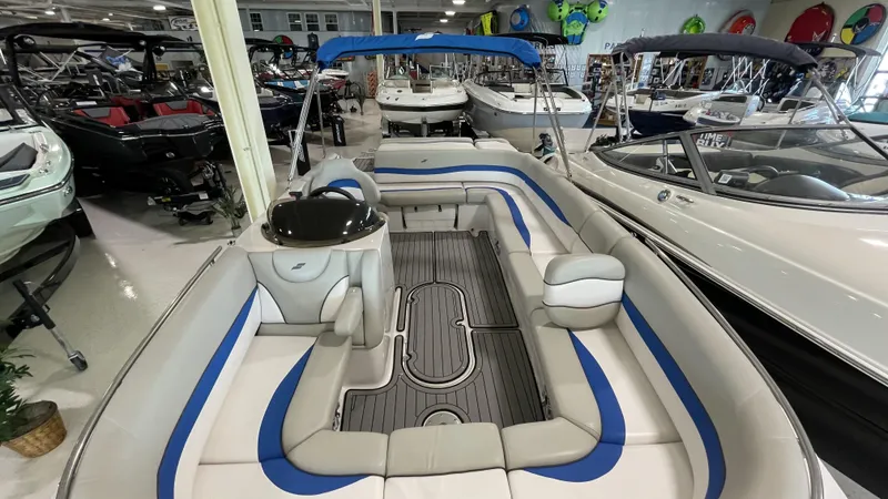 Slide: The Image of 2019 Starcraft Starstep 221 boat interior with blue and gray seating in showroom. - 5