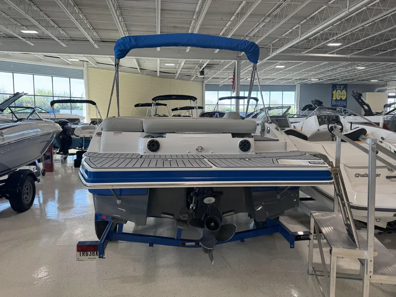 Slide: The Image of 2019 Starcraft Starstep 221 boat displayed in showroom, featuring blue and white design. - 7