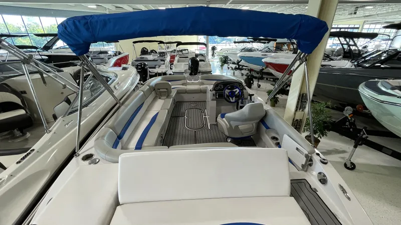 Slide: The Image of 2019 Starcraft Starstep 221 boat interior with blue canopy in showroom. - 8