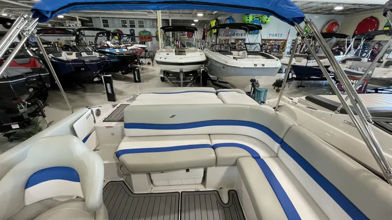 Slide: The Image of 2019 Starcraft Starstep 221 boat interior with blue and white seating in showroom. - 9