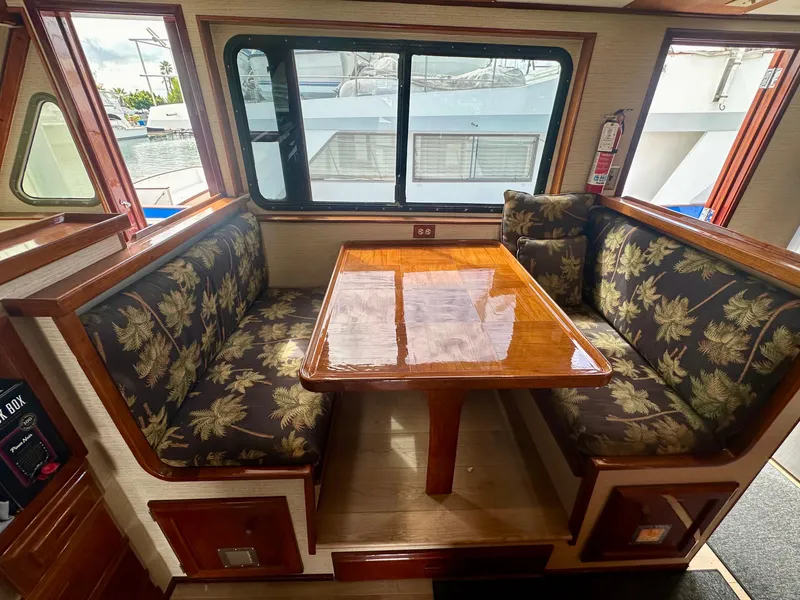 Slide: The Image of 1976 Ditmar & Donaldson Custom Yachtfisher interior with floral upholstery and wooden table. - 15