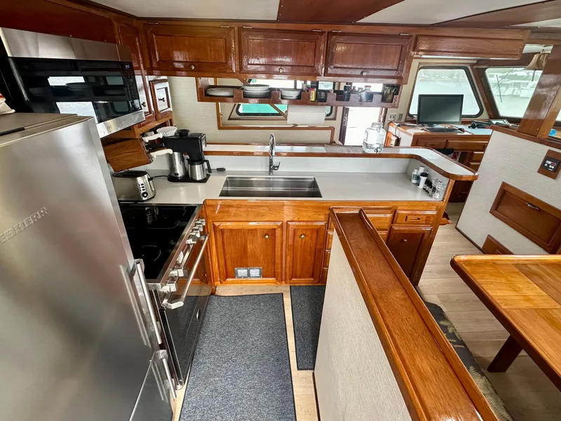 Slide: The Image of 1976 Ditmar & Donaldson Custom Yachtfisher kitchen with wood cabinetry and modern appliances. - 18