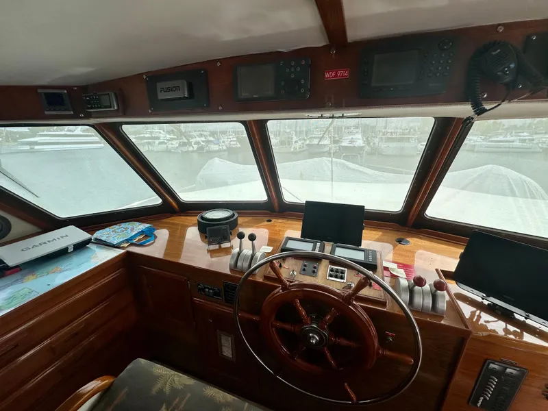 Slide: The Image of 1976 Ditmar & Donaldson Custom Yachtfisher helm with wooden steering wheel and navigation equipment. - 20