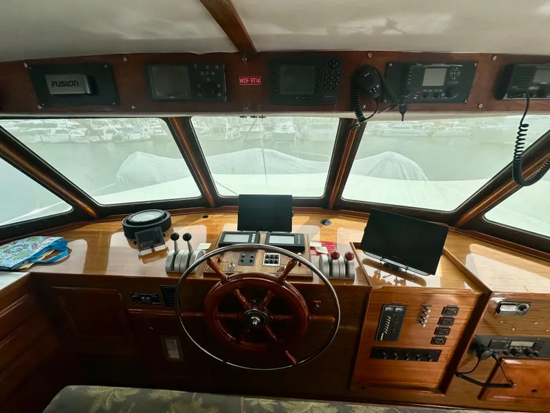Slide: The Image of 1976 Ditmar & Donaldson Custom Yachtfisher helm with wooden steering wheel and navigation equipment. - 22