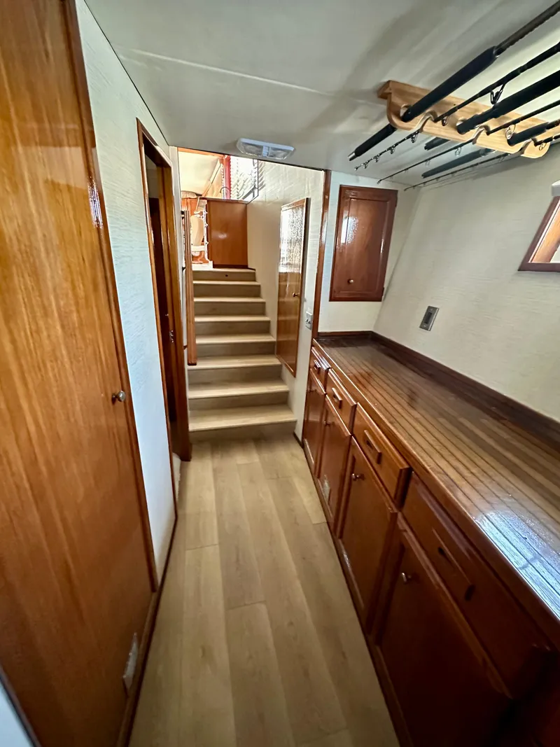 Slide: The Image of Interior of 1976 Ditmar & Donaldson Custom Yachtfisher with wooden cabinetry and stairs. - 25