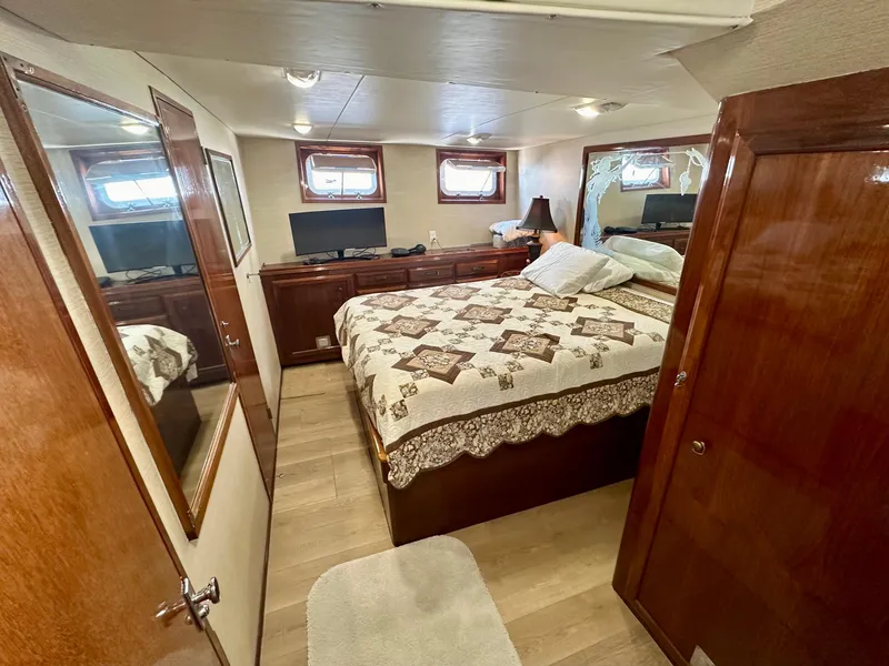 Slide: The Image of Luxurious 1976 Ditmar & Donaldson Custom Yachtfisher bedroom with wood paneling and cozy decor. - 27