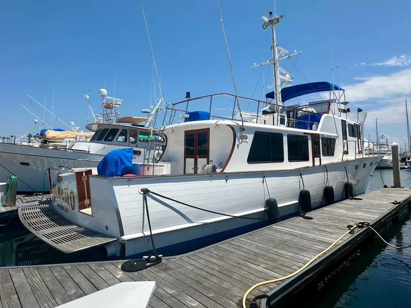 Slide: The Image of 1976 Ditmar & Donaldson Custom Yachtfisher docked at marina under clear blue sky. - 3