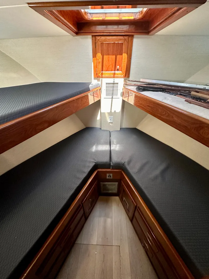 Slide: The Image of 1976 Ditmar & Donaldson Custom Yachtfisher cabin with wooden accents and twin berths. - 31