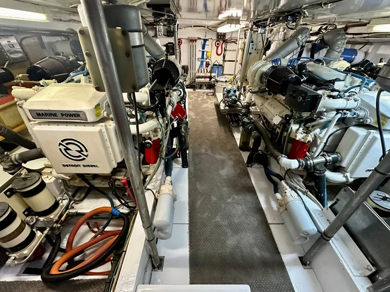 Slide: The Image of Engine room of a 1976 Ditmar & Donaldson Custom Yachtfisher, showcasing dual marine engines. - 34