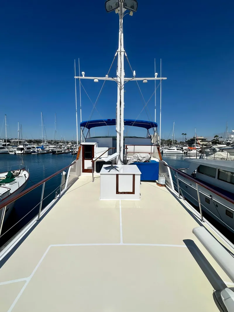 Slide: The Image of 1976 Ditmar & Donaldson Custom Yachtfisher docked in a marina under clear blue skies. - 9