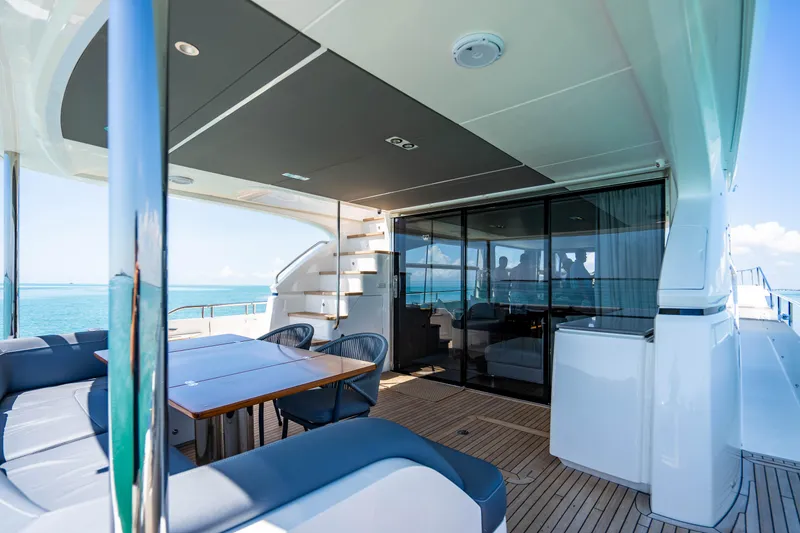 Slide: The Image of 2018 Princess Y75 Motor Yacht deck with seating and dining area. - 24