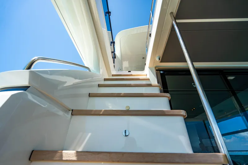 Slide: The Image of Staircase on 2018 Princess Y75 Motor Yacht under clear blue sky. - 33