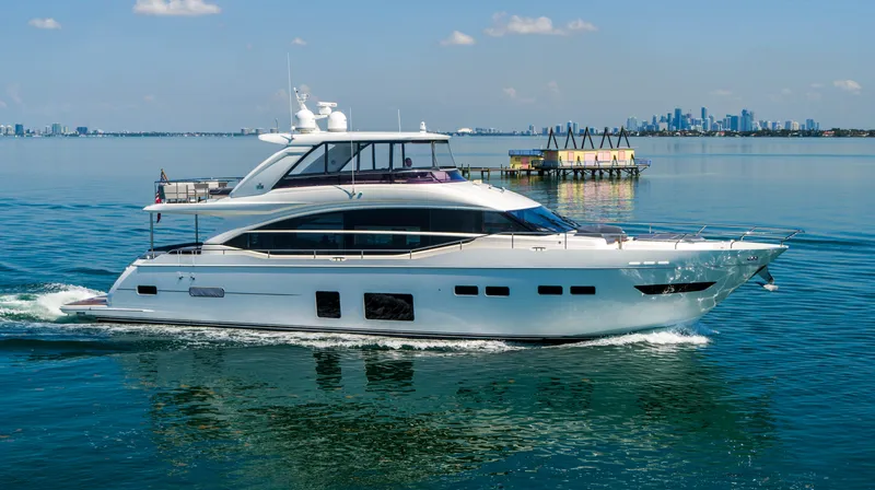 Slide: The Image of 2018 Princess Y75 Motor Yacht cruising on calm waters with city skyline in background. - 4
